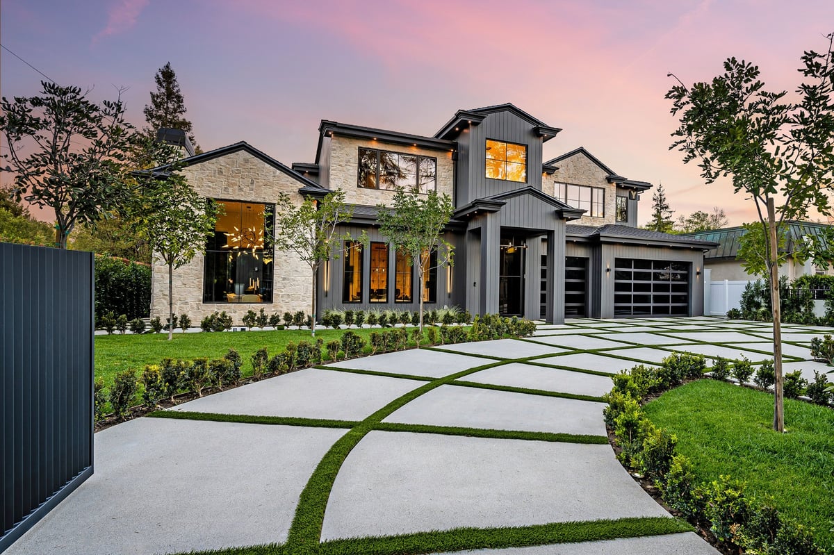 Attractive residential home with a well-kept lawn at sunset