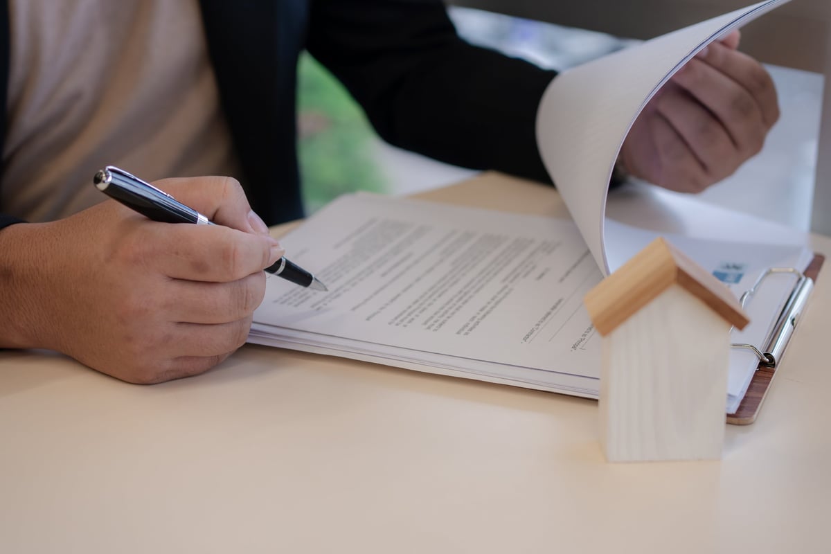 Close-up of a contract being signed for a real estate acquisition