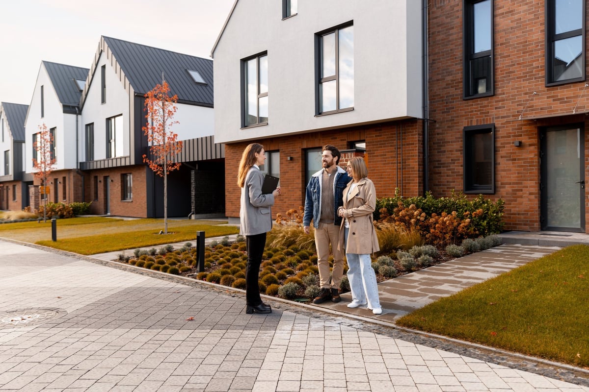 Real estate agent discussing home buying options with clients